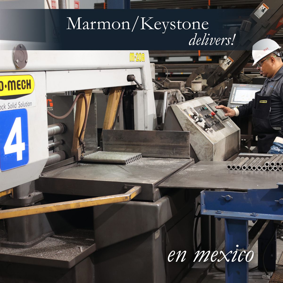Marmon Keystone A worker operates industrial machinery in a factory setting by Marmon/Keystone. Metal tubes and equipment are visible, with signs in English and Spanish. Text on the image reads: "Marmon/Keystone delivers! en mexico.